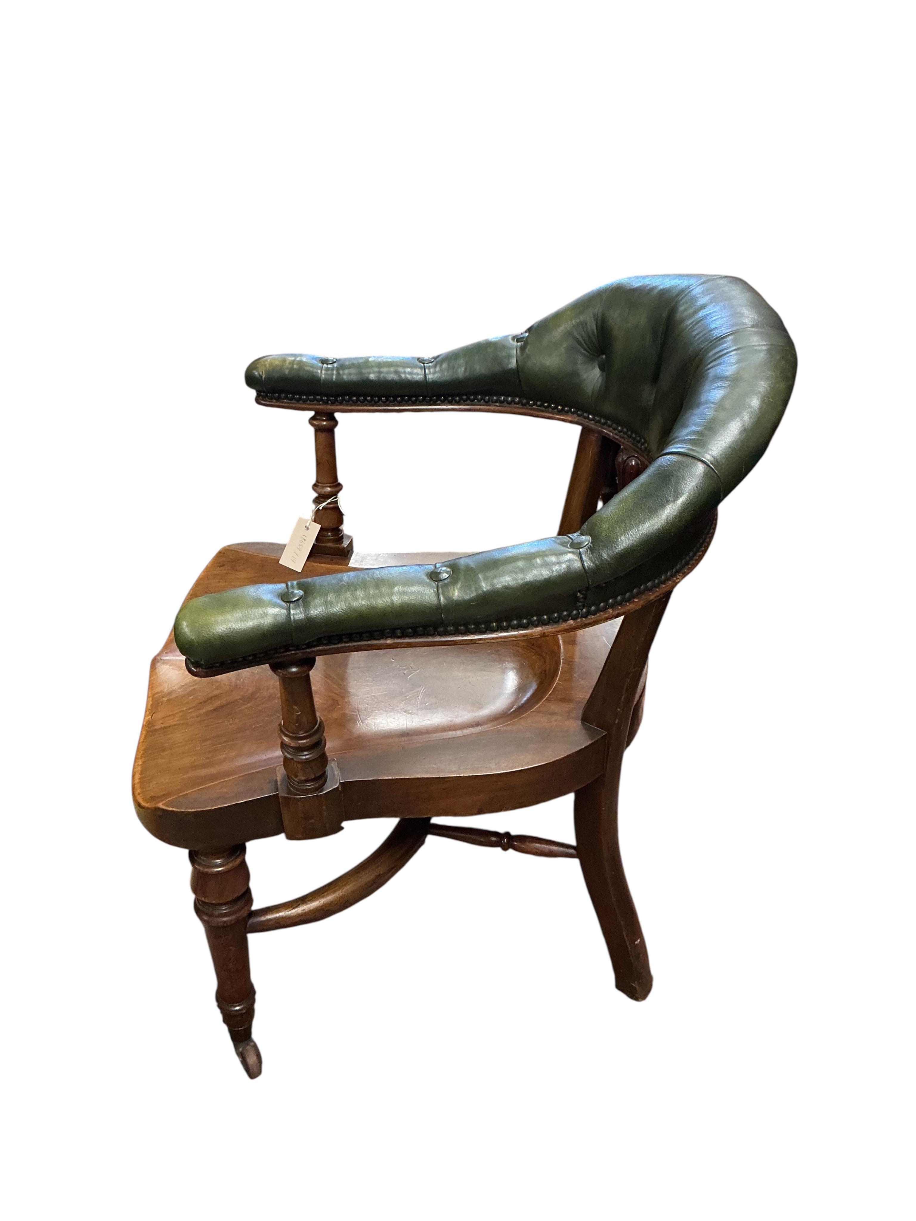 A Victorian mahogany and green buttoned leather desk chair, width 62cm, depth 60cm, height 85cm